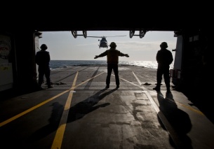 A helicopter landing on the deck of the Italian warship Aliseo