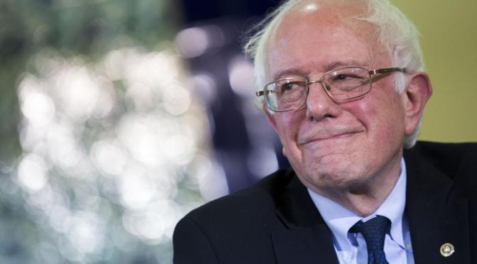 Senator Bernie Sanders, an independent from Vermont and 2016 Democratic presidential candidate, smiles during an interfaith roundtable in Washington, D.C., U.S., on Wednesday, Dec. 16, 2015. Sanders said figures like Trump attempt to "divide" Americans. "A few months ago we're supposed to hate Mexicans and he thinks they're all criminals and rapists and now we're supposed to hate Muslims, and that kind of crap is not going to work in the United States of America," he said. Photographer: Drew Angerer/Bloomberg via Getty Images