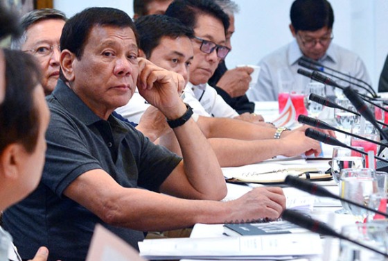 In this photo provided by the Presidential Communications Operations Office, Philippine President Rodrigo Duterte listens during a special cabinet meeting in Davao city, southern Philippines, Thursday, May 25, 2017. Duterte declared 60 days of martial law on Tuesday across the southern third of the nation, an area that includes Marawi but extends well beyond it. ISIS-linked militants launched a violent siege in Marawi that sent thousands of people fleeing for their lives and raised fears of extremists gaining traction in the country. Presidential Communications Operations Office via AP